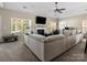 Spacious living room with a fireplace, large windows, and comfortable seating, ideal for relaxation at 13510 Brandon Trail Dr, Charlotte, NC 28213