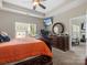 Spacious main bedroom with a ceiling fan, sitting area and a flat screen TV at 13510 Brandon Trail Dr, Charlotte, NC 28213