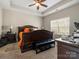 Comfortable main bedroom features a ceiling fan, large bed, and natural light, ideal for relaxation at 13510 Brandon Trail Dr, Charlotte, NC 28213