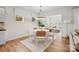 Bright dining area with a round table, stylish chairs, modern chandelier, and wood floors at 13709 Roderick Dr # 193, Huntersville, NC 28078