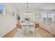 Bright dining area with a round table, stylish chairs, modern chandelier, and wood floors at 13709 Roderick Dr # 193, Huntersville, NC 28078