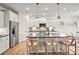 Modern kitchen with stainless steel appliances, a large island with bar seating, and white cabinetry at 13709 Roderick Dr # 193, Huntersville, NC 28078