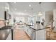 Bright kitchen with a large island, stainless steel appliances, and an open view to the dining area at 13709 Roderick Dr # 193, Huntersville, NC 28078