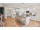 Modern kitchen featuring an island with seating, stainless appliances, and white cabinets at 13709 Roderick Dr # 193, Huntersville, NC 28078