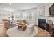 Bright open living area with fireplace, neutral furnishings, and access to dining area at 13709 Roderick Dr # 193, Huntersville, NC 28078