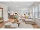 Bright open living area with kitchen and dining area views, neutral furnishings, and wood floors at 13709 Roderick Dr # 193, Huntersville, NC 28078