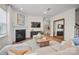 Cozy living room with a fireplace, neutral furnishings, and ample natural light at 13709 Roderick Dr # 193, Huntersville, NC 28078