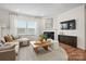 Inviting living room featuring a fireplace, hardwood floors, and stylish neutral decor at 13709 Roderick Dr # 193, Huntersville, NC 28078