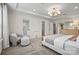 This primary bedroom boasts neutral walls, a tray ceiling, carpet floors, and a doorway to the ensuite bathroom at 13709 Roderick Dr # 193, Huntersville, NC 28078