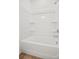This sleek, white tub and shower combination offers modern convenience in this luxurious bathroom at 13709 Roderick Dr # 193, Huntersville, NC 28078