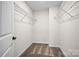 Inside the walk-in closet, find neutral walls and carpeting, plus built-in wire racks for functional storage at 13709 Roderick Dr # 193, Huntersville, NC 28078