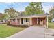 Brick home featuring an attached carport and mature landscaping with shrubs along the front of the house at 140 Mickle Ct, Rock Hill, SC 29732