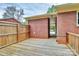 Wooden deck outside of a red brick home with a partial view of the backyard and trees at 140 Mickle Ct, Rock Hill, SC 29732