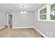 Bright dining room with modern light fixture and vinyl flooring near a large window at 140 Mickle Ct, Rock Hill, SC 29732