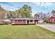 Well-kept home with lush lawn, mature trees, and charming brick exterior and a long driveway at 140 Mickle Ct, Rock Hill, SC 29732