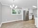 Kitchen boasts white cabinets, stainless steel appliances, gray walls, and wood floors at 140 Mickle Ct, Rock Hill, SC 29732