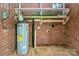 A water heater is attached to a brick wall next to wooden shelves in the basement at 140 Mickle Ct, Rock Hill, SC 29732