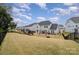 Expansive fenced backyard with a playset offers ample space for recreation and entertaining at 15230 Ravenall Dr, Huntersville, NC 28078