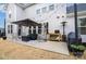 Outdoor patio with a seating area, grill, and umbrella for relaxing and entertaining at 15230 Ravenall Dr, Huntersville, NC 28078