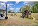 Expansive backyard with play set, swing set, and patio with outdoor seating at 15230 Ravenall Dr, Huntersville, NC 28078