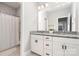 Bright bathroom featuring a dual sink vanity with stone countertops and modern fixtures at 15230 Ravenall Dr, Huntersville, NC 28078