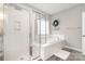 Modern bathroom with glass enclosed shower and separate soaking tub with tiled surround at 15230 Ravenall Dr, Huntersville, NC 28078