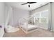 Charming bedroom with playful house frame bed, natural light, and carpeted floors at 15230 Ravenall Dr, Huntersville, NC 28078