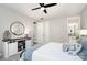 Cozy bedroom featuring a decorative console table, round mirror, and a ceiling fan at 15230 Ravenall Dr, Huntersville, NC 28078