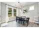 Eat-in kitchen features backyard views, modern lighting, and space for the whole Gathering at 15230 Ravenall Dr, Huntersville, NC 28078