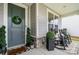 Inviting front porch with rocking chairs, a charming wreath, and a cozy welcome mat for visitors at 15230 Ravenall Dr, Huntersville, NC 28078