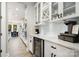 Bright kitchen features sleek white cabinetry, quartz countertops, and stainless steel appliances at 15230 Ravenall Dr, Huntersville, NC 28078