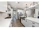 Modern kitchen with stainless appliances, quartz countertops, and large island with sink and dishwasher at 15230 Ravenall Dr, Huntersville, NC 28078