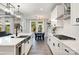 Modern kitchen includes quartz countertops, stainless appliances, large island, and modern light fixtures at 15230 Ravenall Dr, Huntersville, NC 28078