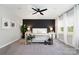 Spacious main bedroom with a striking accent wall and natural light from large windows at 15230 Ravenall Dr, Huntersville, NC 28078