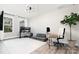Bright home office with ample natural light, desk space, neutral colors, and hardwood floors at 15230 Ravenall Dr, Huntersville, NC 28078