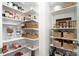 Walk-in pantry features custom shelving and storage solutions for all your food and kitchen needs at 15230 Ravenall Dr, Huntersville, NC 28078