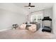 Spacious playroom with comfortable seating, a treadmill, and a ceiling fan at 15230 Ravenall Dr, Huntersville, NC 28078