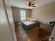 Comfortable bedroom with hardwood floors, a gray bed, and a window providing natural light at 154 Tiger Oak Ln, Rockwell, NC 28138