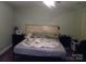 Cozy bedroom with a unique tortilla blanket, wooden headboard, and decorative bedside tables at 154 Tiger Oak Ln, Rockwell, NC 28138
