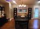 Cozy dining room with stylish lighting, dark wood table, and views of the backyard at 154 Tiger Oak Ln, Rockwell, NC 28138