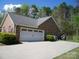 Detached two-car garage with ample parking, surrounded by greenery and set on a concrete driveway at 154 Tiger Oak Ln, Rockwell, NC 28138