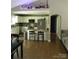 Bright open kitchen featuring modern appliances, a breakfast bar, and hardwood floors throughout at 154 Tiger Oak Ln, Rockwell, NC 28138