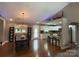 Open-concept kitchen and dining room with white cabinets and modern appliances at 154 Tiger Oak Ln, Rockwell, NC 28138