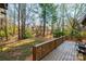 Large backyard with a wooden deck, lush trees, and plenty of space at 1713 12Th Ne St, Hickory, NC 28601