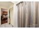 Well-maintained bathroom with a shower curtain, with a hallway and bedroom view at 1713 12Th Ne St, Hickory, NC 28601