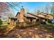 Home's exterior with a wooden deck, chimney, and mature trees at 1713 12Th Ne St, Hickory, NC 28601