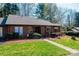 Inviting single story home with brown siding, stone accents, manicured lawn and walkway to the front door at 1713 12Th Ne St, Hickory, NC 28601