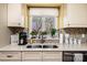 Close-up of the kitchen with stainless steel sink, mosaic backsplash, and bright window at 1713 12Th Ne St, Hickory, NC 28601
