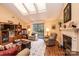 Bright living room with skylights, hardwood floors, fireplace, media center, comfortable seating and a sliding door at 1713 12Th Ne St, Hickory, NC 28601