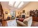 Bright living room featuring skylights, a fireplace, hardwood floors, and comfortable seating with access to a porch at 1713 12Th Ne St, Hickory, NC 28601